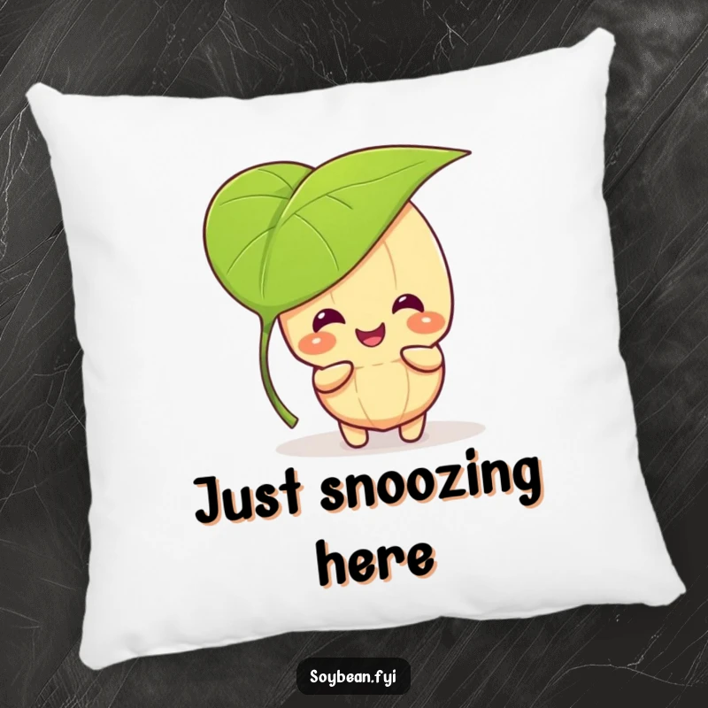 Funny kawaii soybean character giggling and playing peek-a-boo behind a large leaf, on a soft, comfortable pillow.