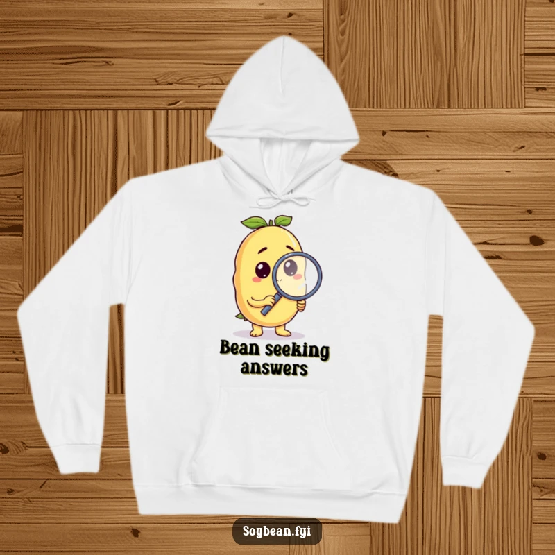 Funny soybean hoodie with a curious anthropomorphic character holding a magnifying glass, perfect for cozy investigation.