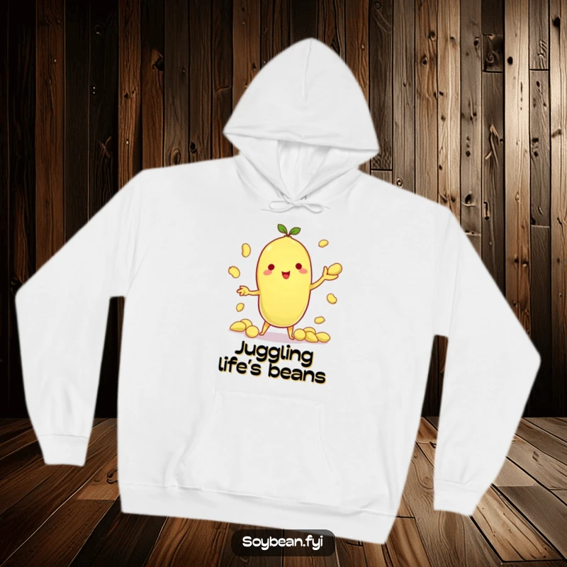 Funny hoodie with a kawaii soybean character skillfully juggling multiple edamame pods, radiating impressive dexterity and fun.