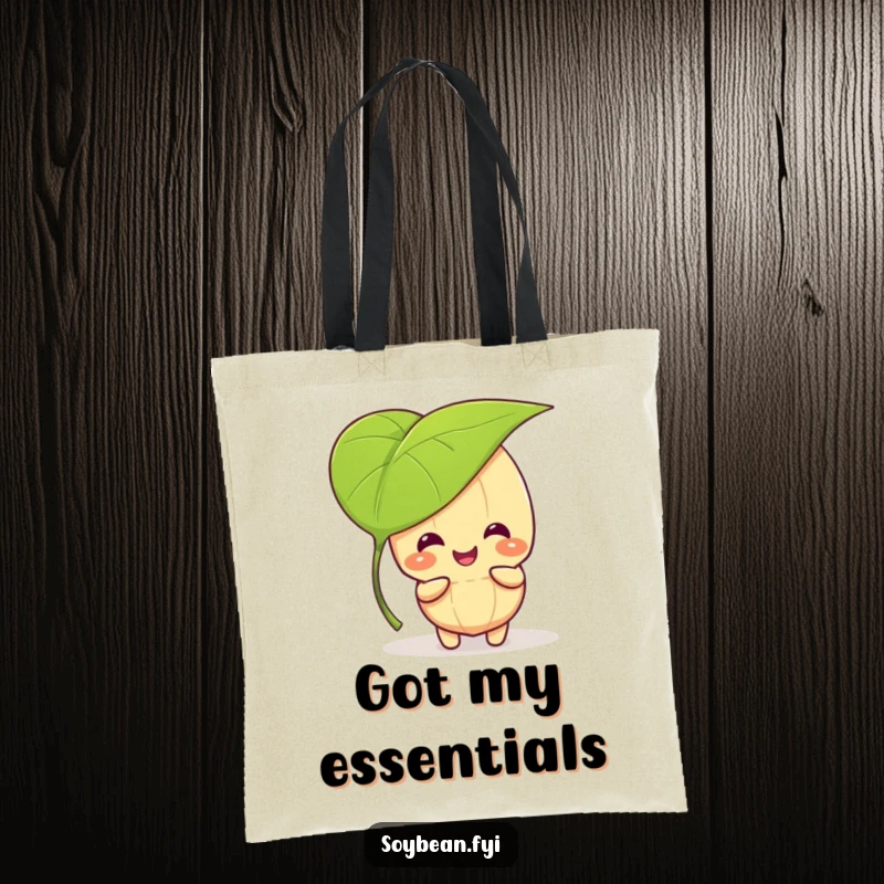 Funny kawaii soybean character giggling and playing peek-a-boo behind a large leaf, printed on a reusable tote bag.